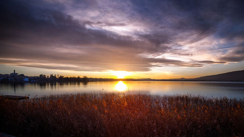 Scenic view of lake against sky during sunset