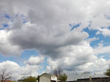 Panoramic view of buildings against cloudy sky