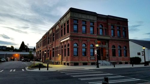 Road by building against sky