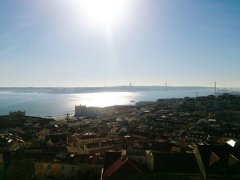 High angle view of town by sea against clear sky