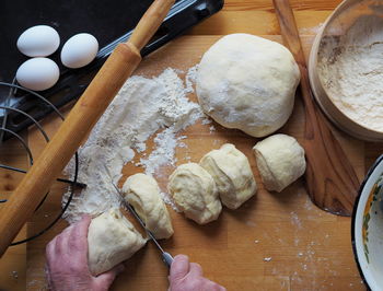 The woman's hands roll out the dough.a woman's hobby.food background.