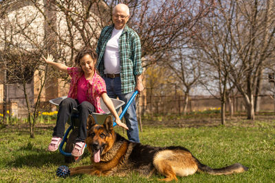 Rear view of woman with dog on field