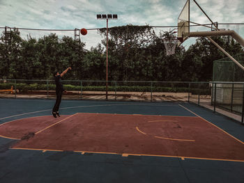 Man playing with ball in background