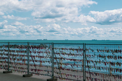 Textile pieces on sea-side against sky