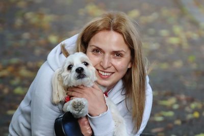 Portrait of smiling woman holding dog