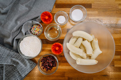 High angle view of banana bread ingredients in bowls on table in kitchen