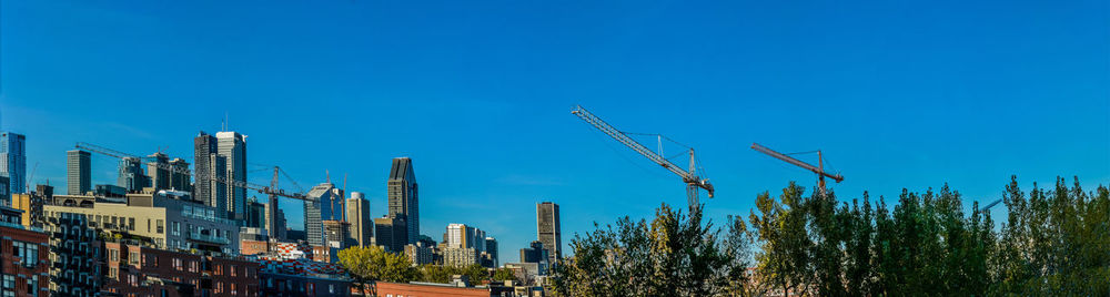 Cityscape against clear blue sky