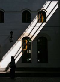 Full length of woman standing in front of building
