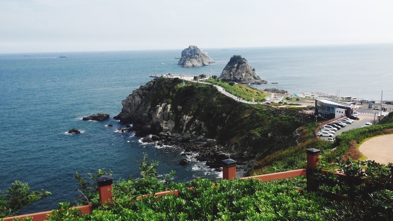 sea, water, horizon over water, scenics, tranquil scene, tranquility, travel destinations, beauty in nature, tourism, vacations, nature, non-urban scene, sky, cliff, day, outdoors, remote, distant, seascape, rock formation, town, coastline, no people