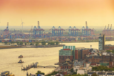 High angle view of harbor by buildings against sky