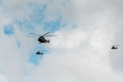 Low angel view of helicopter flying at sky