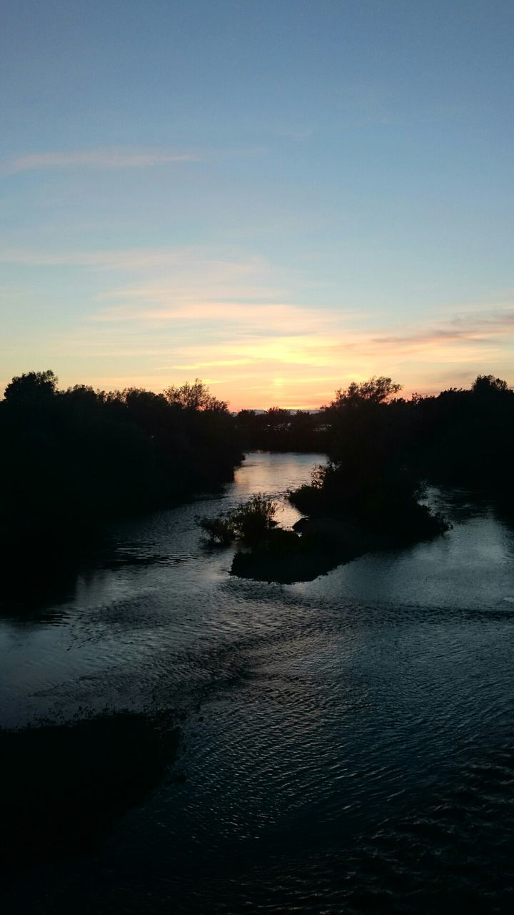 water, sunset, tranquil scene, tranquility, scenics, sky, beauty in nature, reflection, silhouette, lake, nature, river, tree, idyllic, waterfront, rippled, cloud - sky, non-urban scene, outdoors, dusk