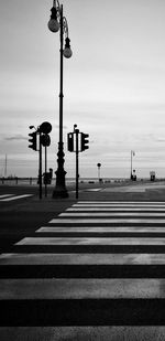 Zebra crossing on road against sky