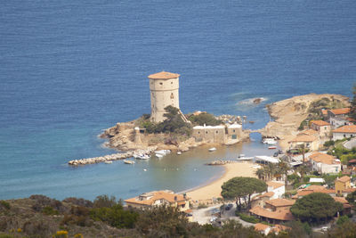 High angle view of buildings by sea