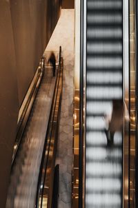 High angle view of man walking on escalator