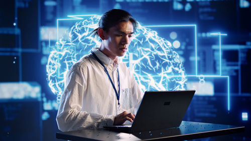 Businesswoman using laptop at office