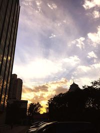 Low angle view of buildings against cloudy sky