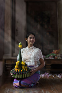 Woman with offerings sitting in temple