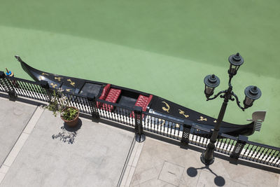 High angle view of lamp post by gondola moored on canal