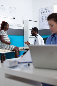 Doctor examining pregnant lady in clinic