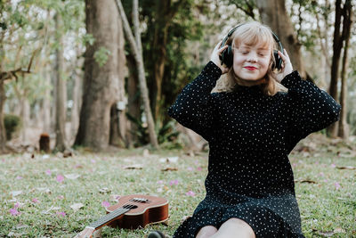 Girl standing by tree
