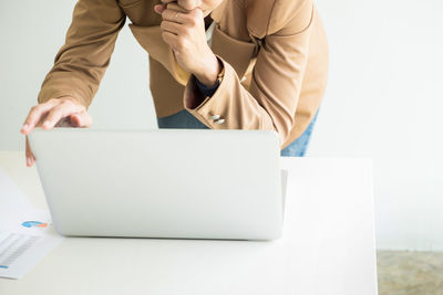 Midsection of man using mobile phone