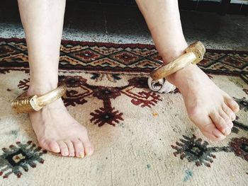 Close-up of legs with jewelry