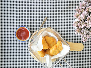 Directly above shot of food in container on tablecloth