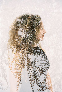 Digital composite image of woman and white flowering plant