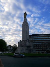 Low angle view of statue against cloudy sky