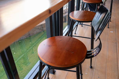 High angle view of empty chairs and table in cafe