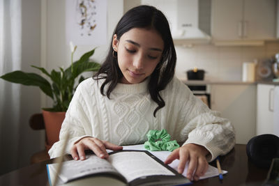 Girl doing homework at dining table