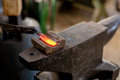 Close up view of heated metal and anvil. the blacksmith in the production process of metal products 