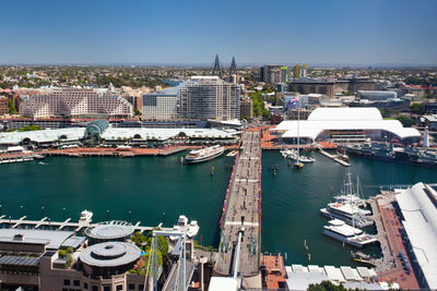 High angle view of harbor by buildings against sky