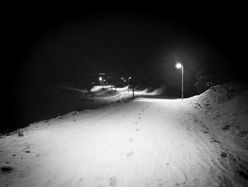 View of illuminated snow covered landscape at night