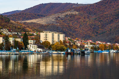 Scenic view of river by buildings in city