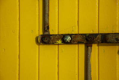 Close-up of yellow door handle