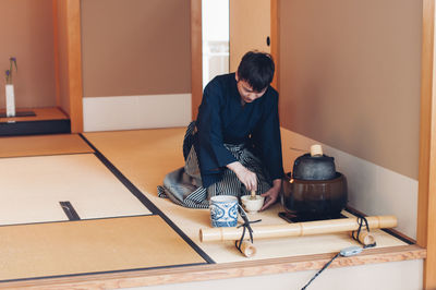 Full length of a man sitting at table