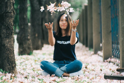 Portrait of a smiling woman sitting on land