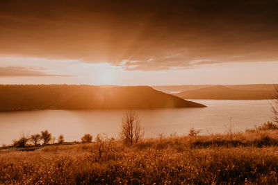 Scenic view of field against sky during sunset