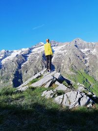 Full length of man standing on mountain against sky