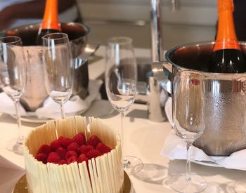 Close-up of champagne with raspberries on table