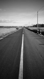 Road by landscape against sky