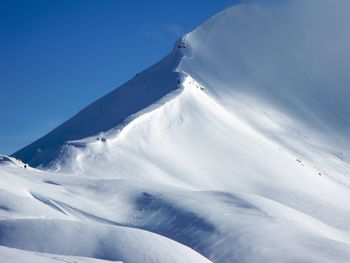 Scenic view of snow covered mountain against sky