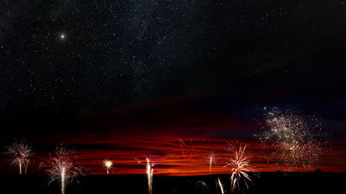 Low angle view of fireworks in sky at night