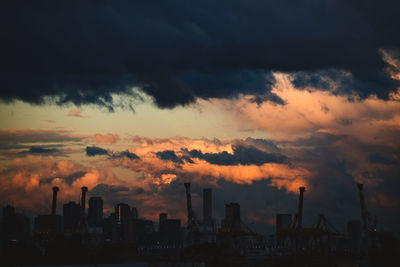 Silhouette buildings against sky during sunset