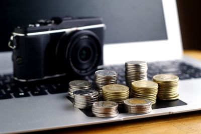 Close-up of coins on laptop against camera