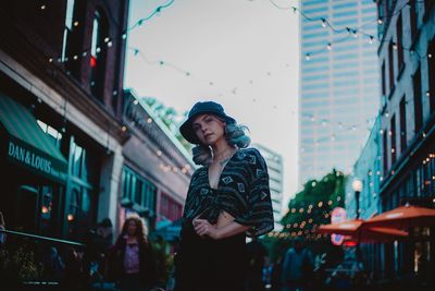 Woman standing against buildings in city