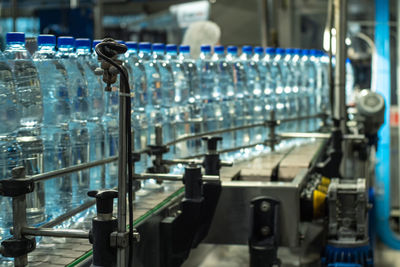 Blue plastic mineral water bottles on a conveyor line. food production.