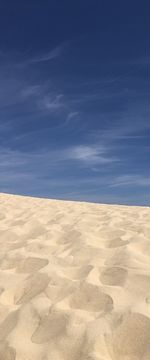 Scenic view of desert against blue sky